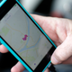 A Lyft driver opens the Lyft app on his phone while waiting for a fare in Pittsburgh.